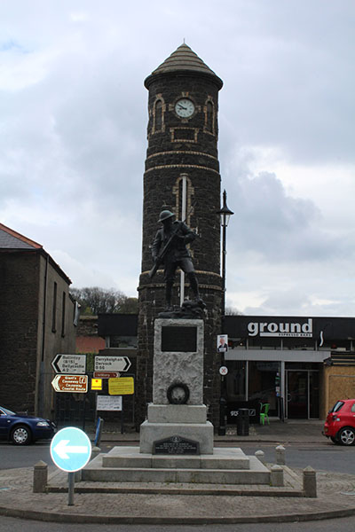 The Bushmills War Memorial statue in front of the Market Square clock tower