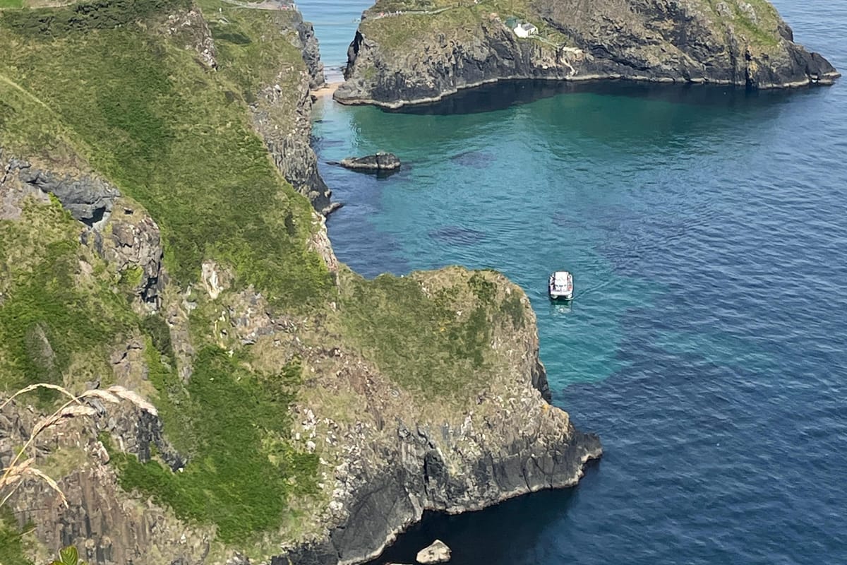 An aerial view of Carrick-a-Rede island and the surrounding cliffs and sea