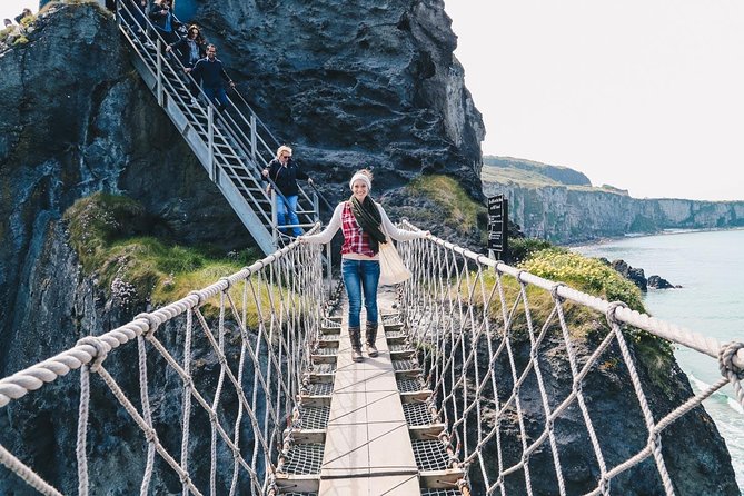 A woman crossing Carrick-a-Rede Rope Bridge