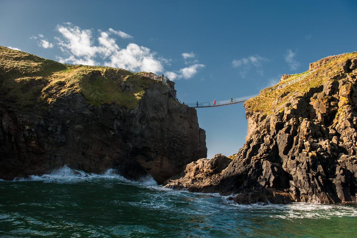 Carrick-a-Rede Rope Bridge seen from a boat on the water below
